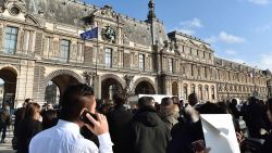 People stand in front of the Louvre museum on February 3, 2017 in Paris after a soldier has shot and gravely injured a man who tried to attack him."Serious public security incident under way in Paris in the Louvre area," the interior ministry tweeted on February 3 as streets in the area were cordoned off to traffic and pedestrians.  / AFP / ALAIN JOCARD        (Photo credit should read ALAIN JOCARD/AFP/Getty Images)