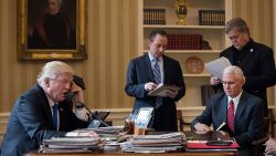 WASHINGTON, DC - JANUARY 28: President Donald Trump speaks on the phone with Russian President Vladimir Putin in the Oval Office of the White House, January 28, 2017 in Washington, DC. Also pictured, from left, White House Chief of Staff Reince Priebus, Vice President Mike Pence, and White House Chief Strategist Steve Bannon. On Saturday, President Trump is making several phone calls with world leaders from Japan, Germany, Russia, France and Australia.