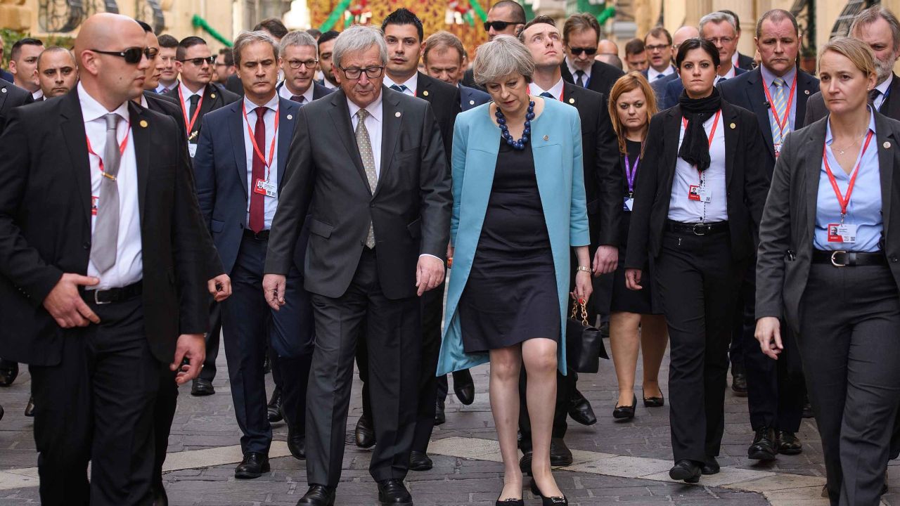 President of the European Union Jean-Claude Juncker and British Prime Minister Theresa May walk between photo calls at a summit in Malta in February.
