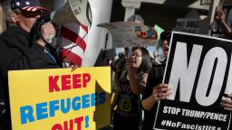 LOS ANGELES, CA - JANUARY 29:  A protester faces off with a supporter of U.S. President Donald Trump during a demonstration against the immigration ban that was imposed by  President Trump at Los Angeles International Airport on January 29, 2017 in Los Angeles, California. Thousands of protesters gathered outside of the Tom Bradley International Terminal at Los Angeles International Airport to denounce the travel ban imposed by President Trump. Protests are taking place at airports across the country.  (Photo by Justin Sullivan/Getty Images)