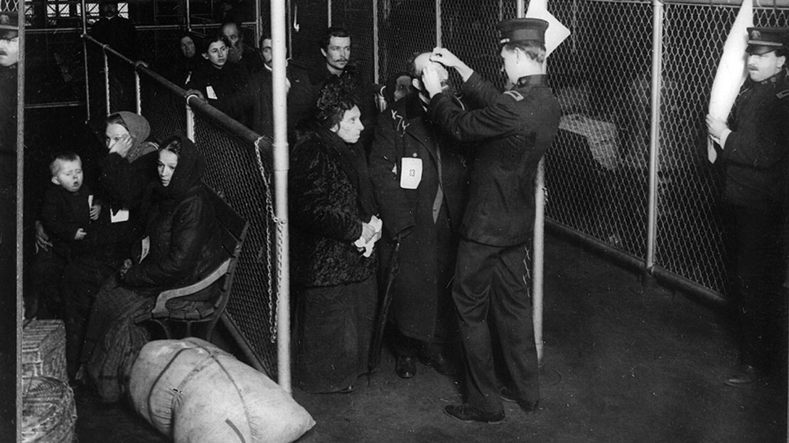 US inspectors examine the eyes of immigrants at Ellis Island in New York Harbor, in the early 1900s.