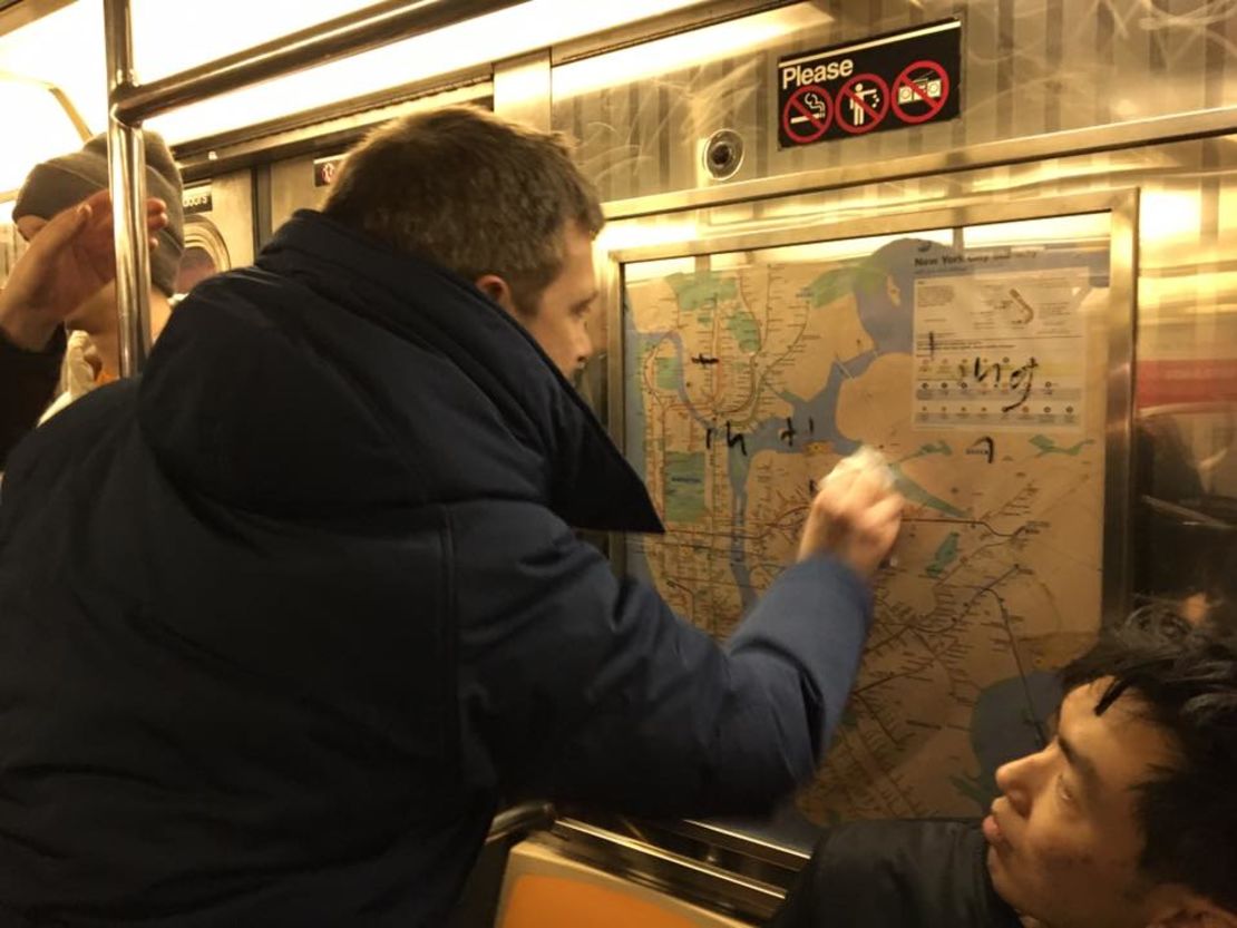 Chef Jared Nied scrubs graffiti from the subway car Saturday night.