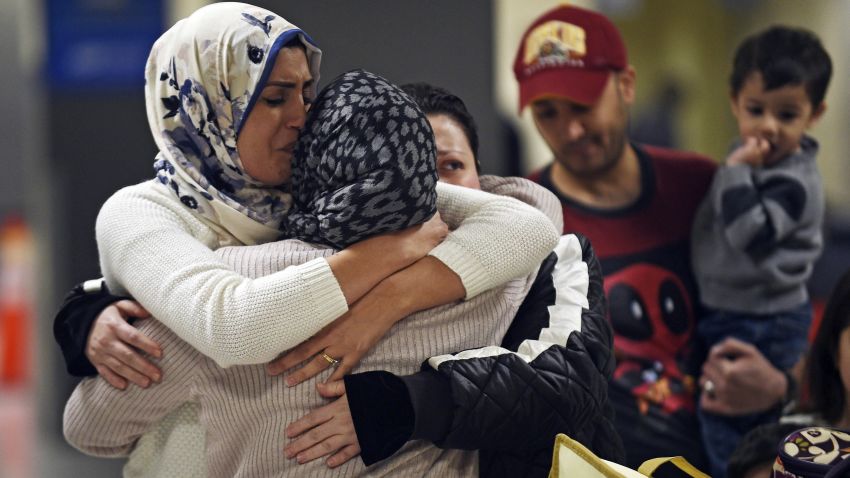 An Iraqi family from Woodbridge, Virginia, welcomes their grandmother at Dulles International Airport in Sterling, Virginia on February 5, 2017. The grandmother, who holds a US green-card, was visiting her daughter who had given birth in Iraq but could not return to the US due to a travel ban in place after US President Trump signed an executive order. 