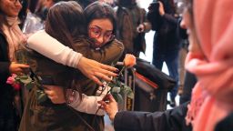 BOSTON - FEBRUARY 3: Banah Alhanfy, from Ira, is hugged and handed a rose after arriving at Logan International Airport in Boston on Feb. 3, 2017. Banah was initially not allowed to enter the US after President Donald Trump's travel ban. (Photo by John Tlumacki/The Boston Globe via Getty Images)