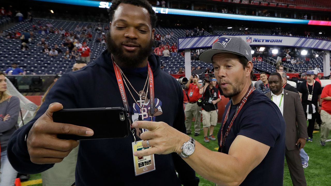 Seattle defensive end Michael Bennett takes a selfie with actor Mark Wahlberg before the game. Bennett's brother Martellus plays for the Patriots. Wahlberg is a Patriots fan.
