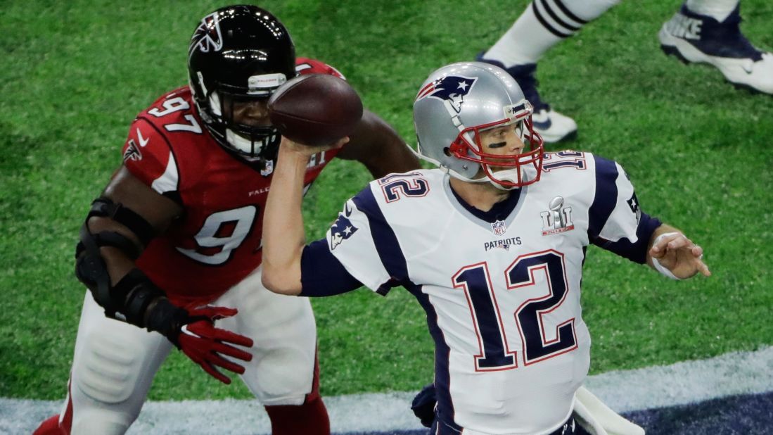 Brady is pressured by Jarrett, who got one of Atlanta's two first-half sacks.