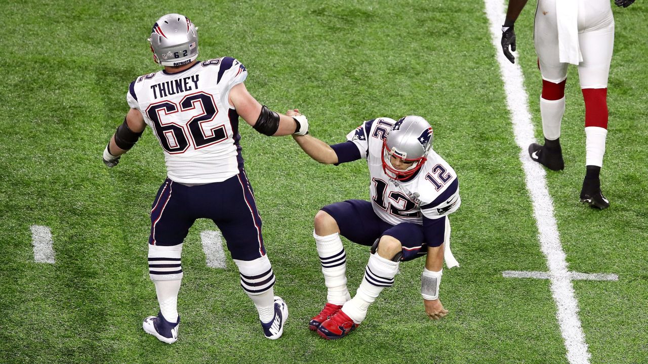 Brady is helped up by one of his linemen, Joe Thuney.