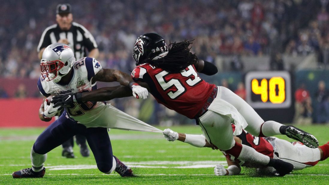 White is tackled by Atlanta's Jalen Collins, bottom, and De'Vondre Campbell in the second half.