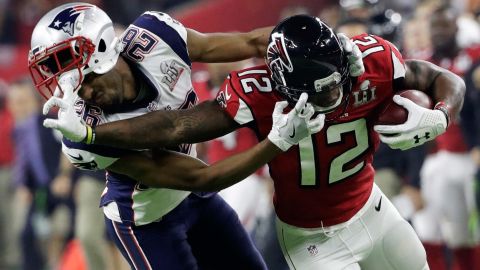 Atlanta wide receiver Mohamed Sanu tussles with New England's Logan Ryan during the second half.