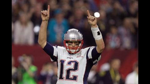 Brady raises his arms after a touchdown late in the second half.