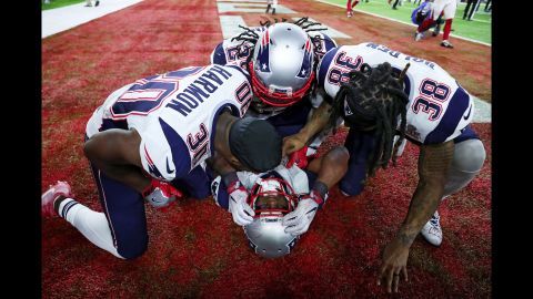 New England running back James White is mobbed by his teammates after scoring the game-winning touchdown in overtime. White ran it in from two yards away after a pass interference penalty on Atlanta.