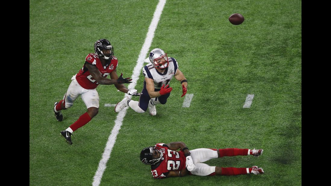 Tom Brady's pass over the middle was deflected by Atlanta cornerback Robert Alford, right. It hung in the air and appeared as though it could be intercepted, ending the Patriots' drive with 2:30 remaining in the game.