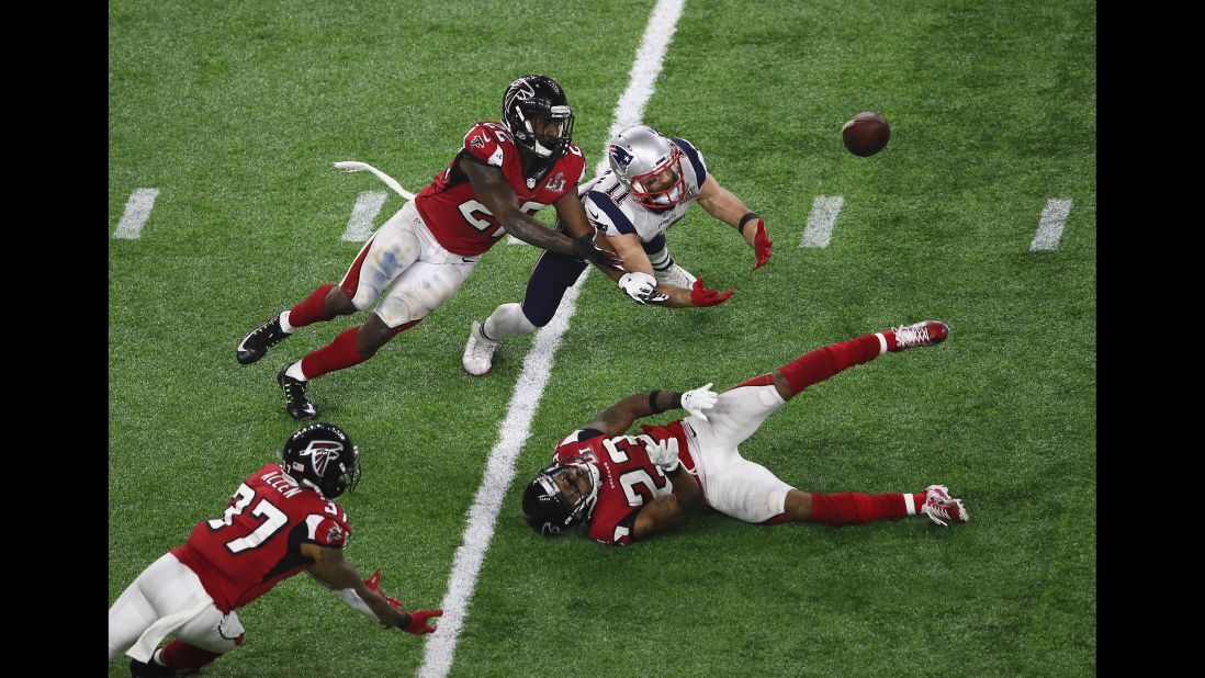 Edelman dove for the ball, as did Atlanta defenders Ricardo Allen, left, and Keanu Neal.