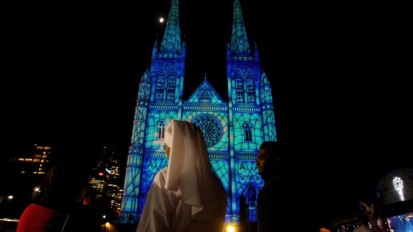 SYDNEY, AUSTRALIA - DECEMBER 12:  A Catholic nun looks on as the 2013 Lights Of Christmas are launched at St Mary's Cathedral on December 12, 2013 in Sydney, Australia. Lights of Christmas is an annual event illuminating the facade of St Mary's Cathedral to celebrate the spirit of Christmas.  (Photo by Lisa Maree Williams/Getty Images)