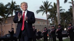 President Donald Trump listens to the Palm Beach Central High School Band as they play at his arrival at Trump International Golf Club in West Palm Beach, Florida Sunday, February 5, 2017. 