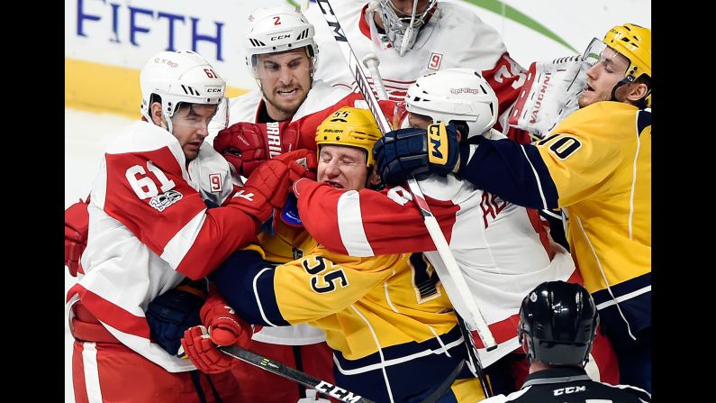 Nashville forward Cody McLeod is mobbed by Detroit Red Wings during an NHL hockey game in Nashville, Tennessee, on Saturday, February 4.
