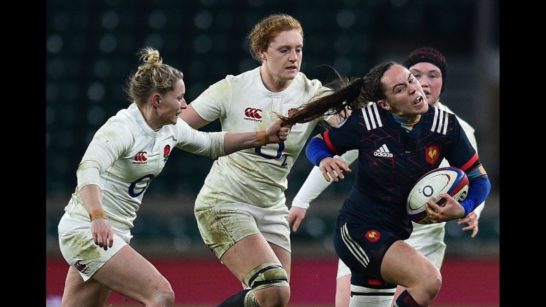 French rugby player Jade Le Pesq has her hair pulled by England's Natasha Hunt during a Six Nations match in London on Saturday, February 4.