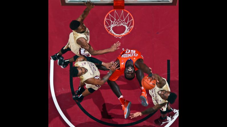 Clemson center Sidy Djitte is surrounded by Florida State players as he tries to pull in a rebound during a college basketball game on Sunday, February 5.