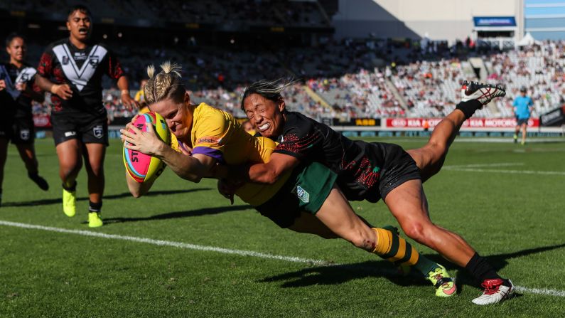 Australia's Chelsea Baker is tackled by New Zealand's Sarina Fiso as she scores a try during an Auckland Nines match in Auckland, New Zealand, on Sunday, February 5. Baker and the Jillaroos swept a three-game series.
