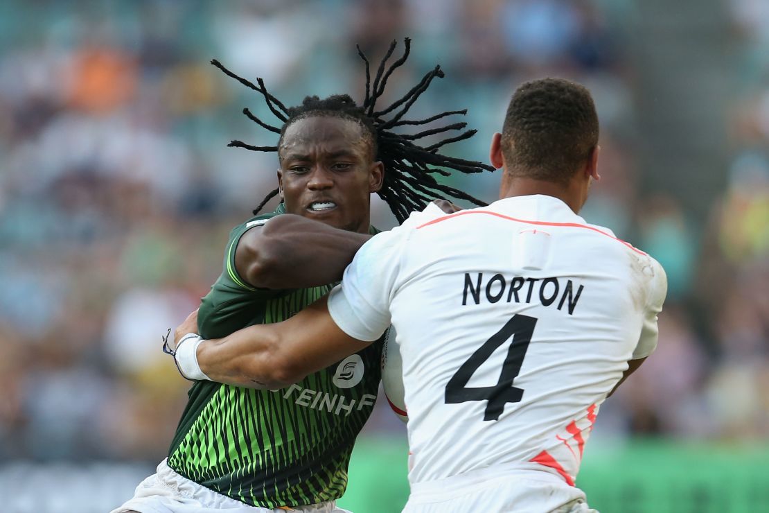 Senatla is tackled by England's Dan Norton, who is now second on the all-time try-scoring list.