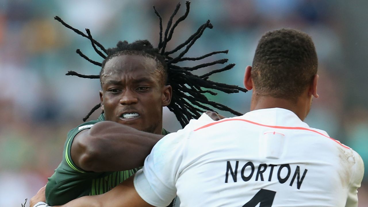 Senatla is tackled by England's Dan Norton, who is now second on the all-time try-scoring list. 