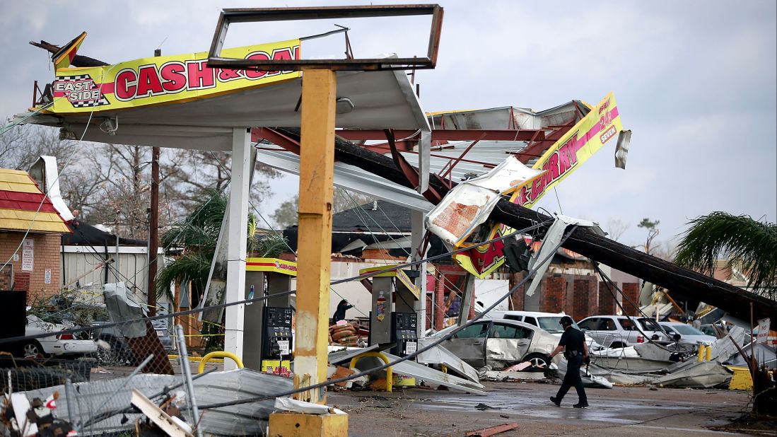 A police officer walks through a damaged gas station along Chef Menteur Highway.