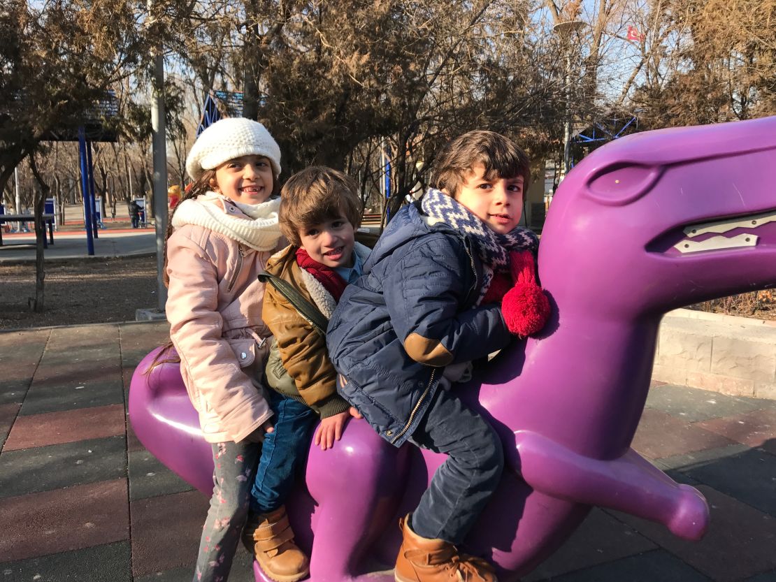 Bana plays in an Ankara park with her two younger brothers.
