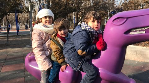 Bana plays in an Ankara park with her two younger brothers.
