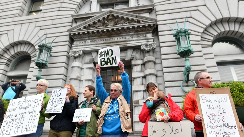 Protesters stand in front of the United States Court of Appeals for the Ninth Circuit in San Francisco, California on February 7, 2017. A federal appeals court heard arguments on Tuesday on whether to lift a nationwide suspension of President Donald Trump's travel ban targeting citizens of seven Muslim-majority countries.