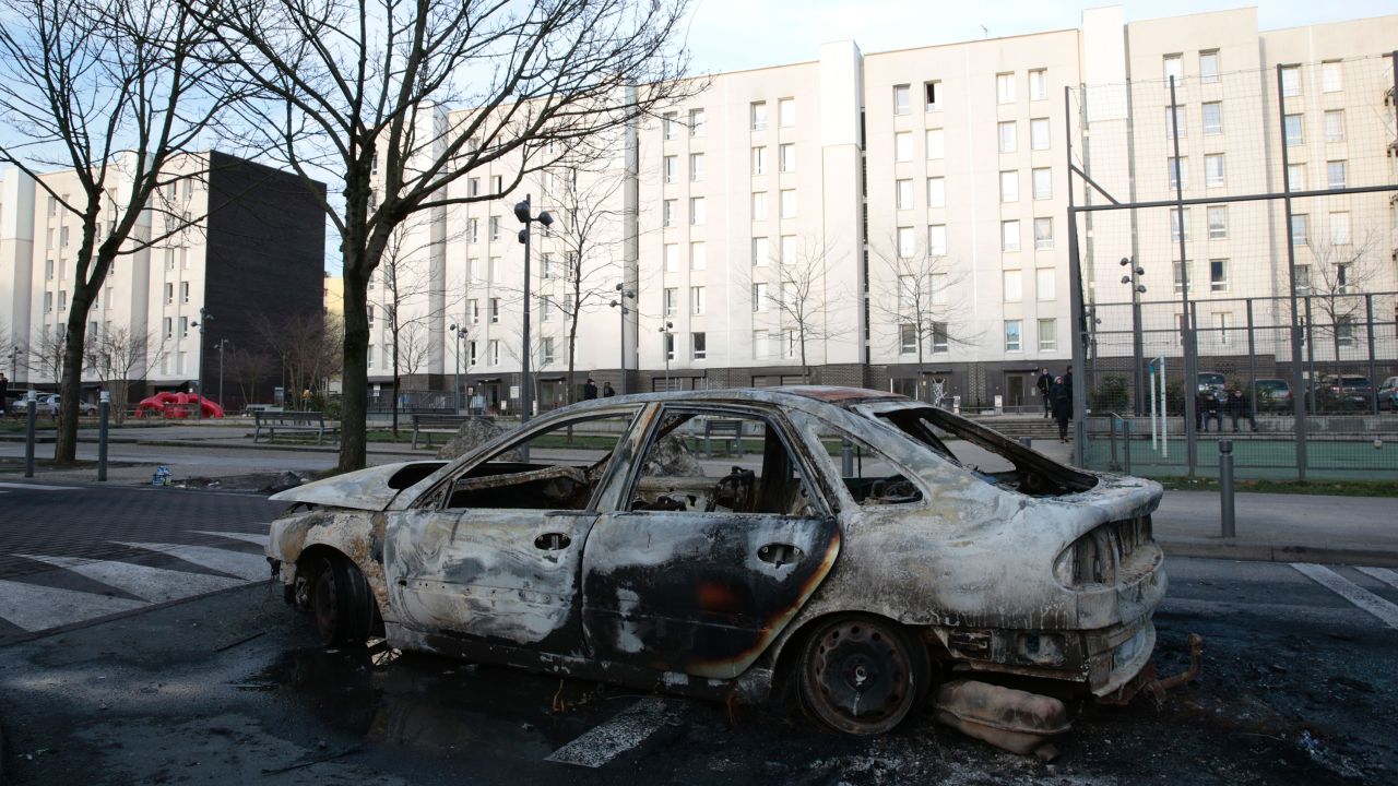 A burned-out car torched in protests.