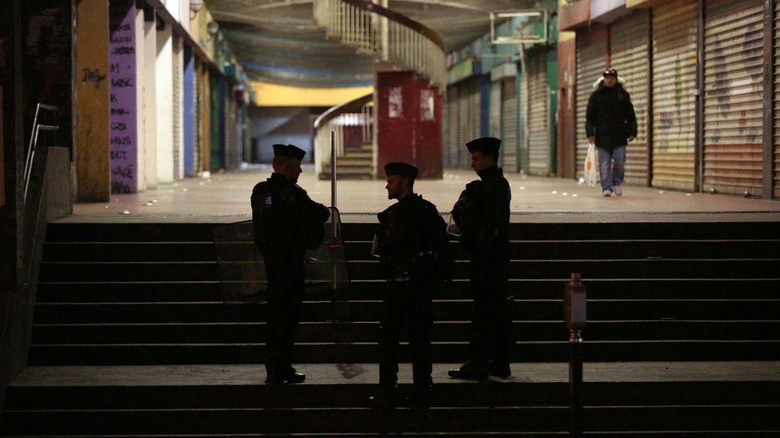 French police stand guard at the housing estate.