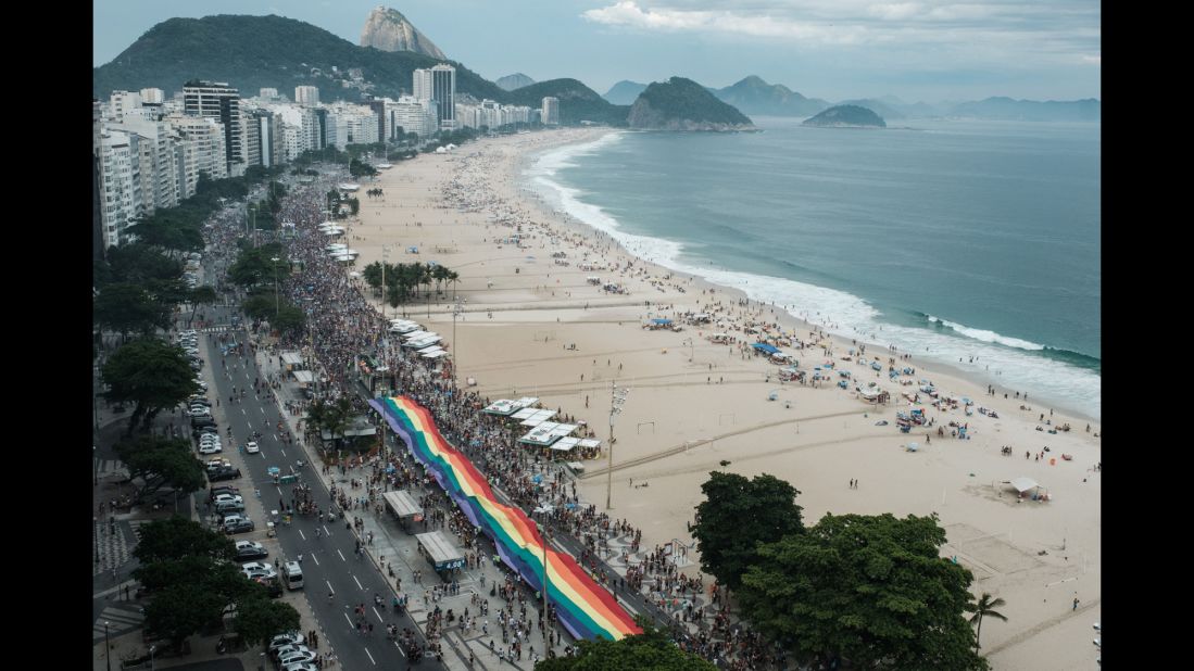Revelers take part in the 21st Rio LGBT pride parade at Copacabana Beach in Rio de Janeiro on December 11, 2016. Same-sex couples have been able to marry in Brazil since 2013 and the country boasts one of the world's largest pride parades.