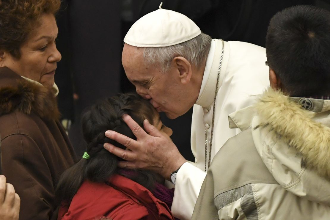 Pope Francis kisses a child during a general audience at the Paul VI Audience Hall at the Vatican on February 8.