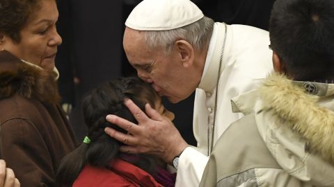 Pope Francis kisses a child during a general audience at the Paul VI Audience Hall at the Vatican on February 8.