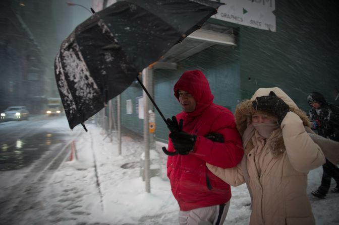 People walk through New York's Times Square during a snowstorm on Thursday, February 9. <a href="index.php?page=&url=http%3A%2F%2Fwww.cnn.com%2F2017%2F02%2F09%2Fus%2Fsnowstorm-northeast-weather%2Findex.html" target="_blank">Winter storm warnings were in effect</a> from Pennsylvania through parts of New York, New Jersey and New England.