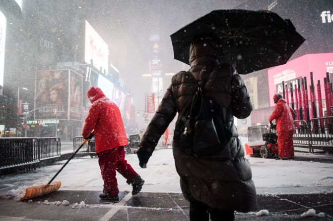 Times Square workers shovel snow on February 9.