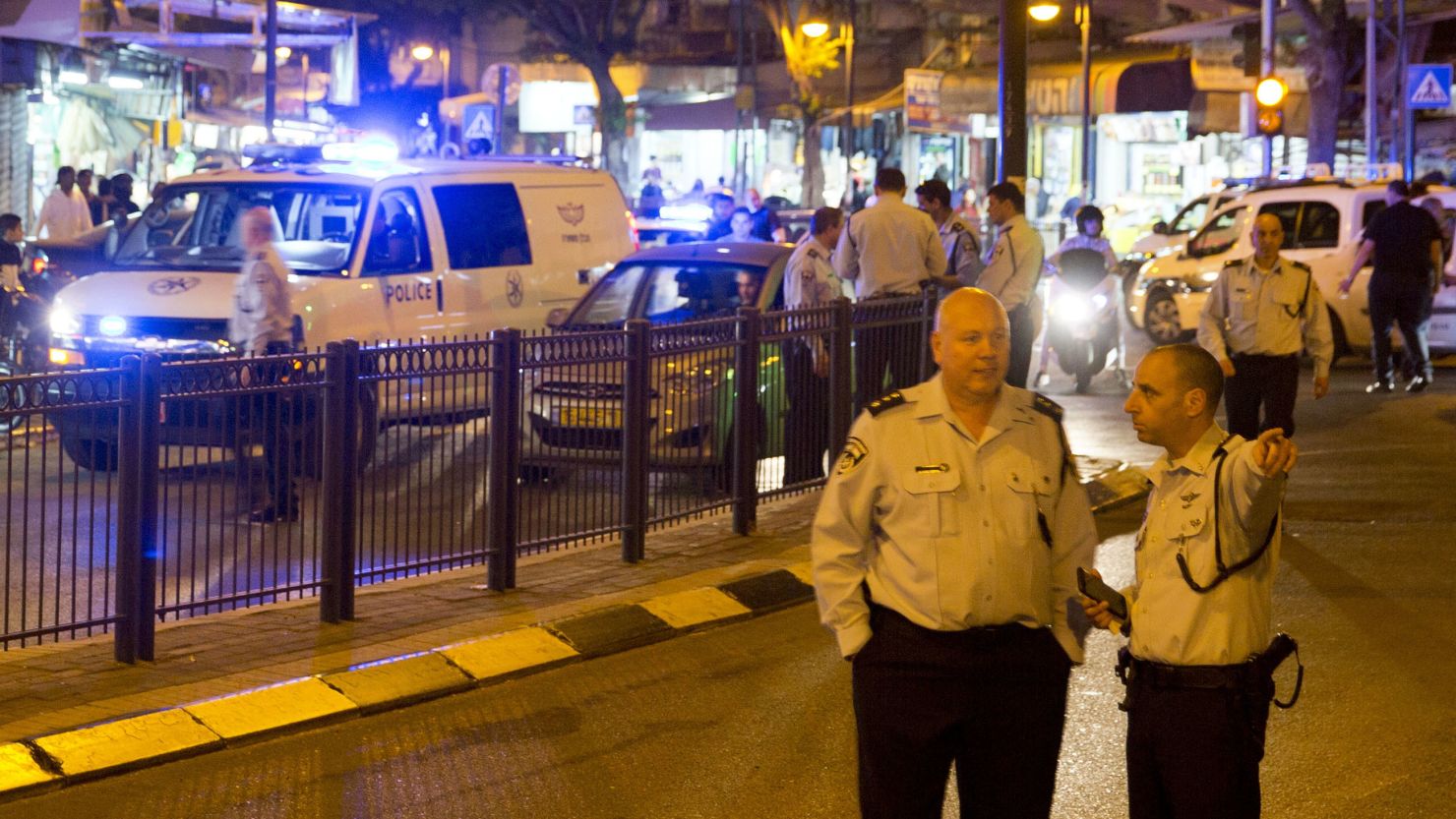 Israeli police officers inspect the scene of  the attack in Petah Tikva.