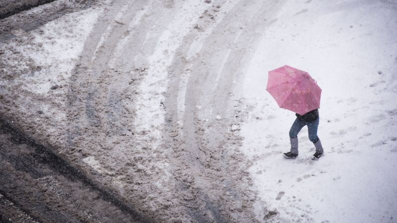 A woman crosses Second Avenue in the East Village of New York on February 9.