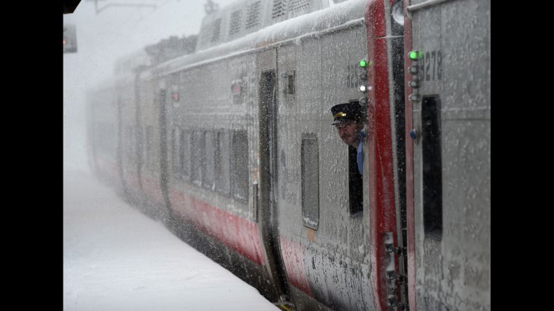 A train conductor looks at the snow in Greenwich, Connecticut.