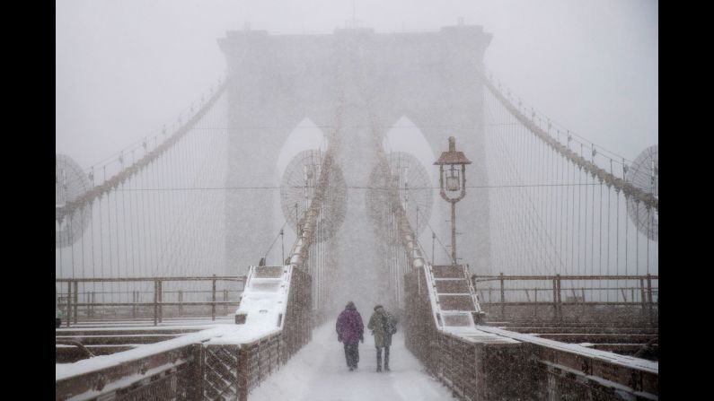 People walk across the Brooklyn Bridge in New York on February 9.