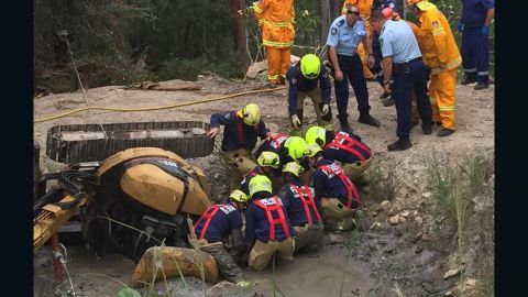 Crews work to free Miller from the muddy pit.