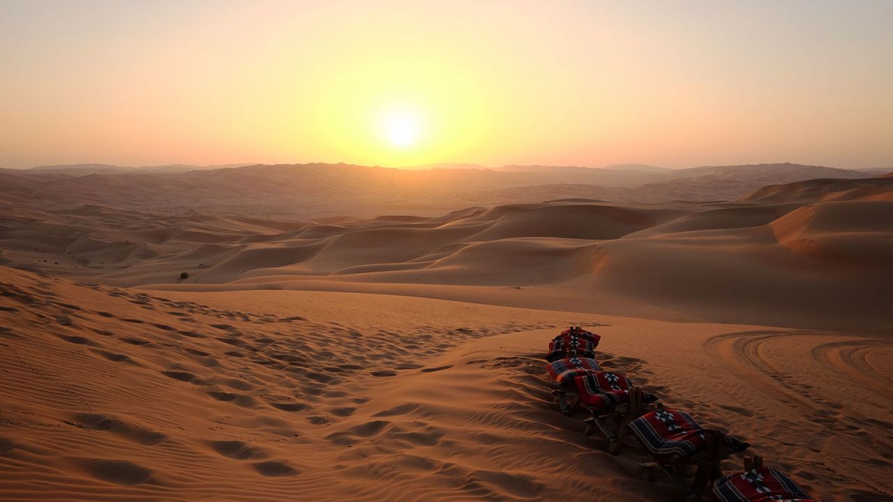 <strong>Sunset tea party:</strong> Both the dune-bashing and camel trek excursions end with a dune-top tea party as the evening sun melts behind the dusty horizon.