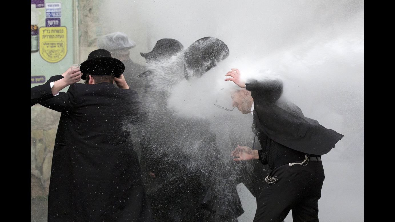 Israeli police use water cannons to disperse ultra-Orthodox Jewish demonstrators in Jerusalem on Thursday, February 9. Thousands of protesters were blocking roads in various locations as they called for the release of a student who was arrested after refusing to join the army.
