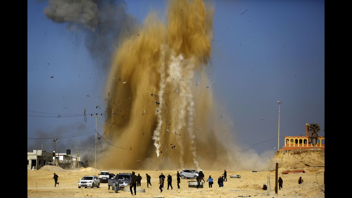 People in northern Gaza run for cover after an Israeli airstrike targeted a Hamas post on Monday, February 6. Israel struck a number of Hamas positions after a projectile from Gaza crashed into a border area, the Israeli army said.