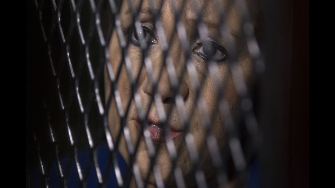 Guatemala Supreme Court Justice Blanca Stalling looks out from a cell at a court in Guatemala City on Wednesday, February 8. Prosecutors say she was arrested on a charge of influence peddling after she tried to help her son in a corruption case. She has denied the accusation.