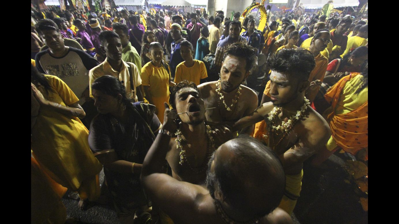 A Hindu devotee is in a state of trance during Thaipusam celebrations in Kuala Lumpur, Malaysia, on Thursday, February 9. During the festival, many people show their devotion by piercing their bodies with tridents, hooks and skewers.