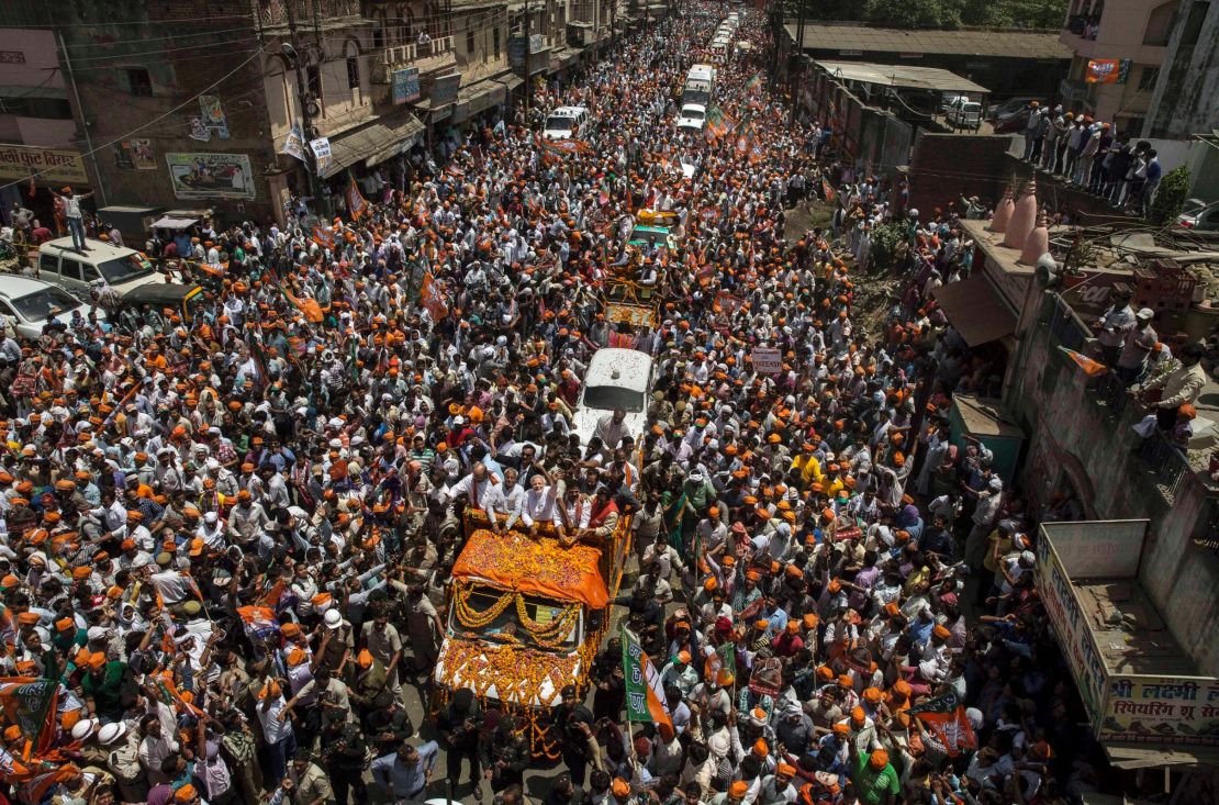 BJP leader Narendra Modi waves to supporters in Varanasi from an open truck in April 2014.