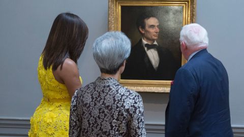 First Lady Michelle Obama and Ho Ching(C), wife of Singapore's Prime Minister Lee Hsien Loong look at a portrait of the 16th President of the US, Abraham Lincoln as they are escorted through the National Gallery of Art in Washington DC, August 2, 2016 by Museum Director Earl "Rusty" Powell III.  