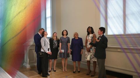 U.S. first lady Michelle Obama (6th R); Jenni Haukio (4th L), spouse of the President of Finland; Sindre Finnes (L), spouse of the Prime Minister of Norway; Ulla Lofven (5th L), spouse of the Prime Minister of Sweden; Solrun Lokke Rasmussen (3rd L), spouse of the Prime Minister of Denmark; and Ingibjorg Elsa Ingjaldsdottir (2nd L), spouse of the Prime Minister of Iceland, visit the art piece, Plexus A1, created by artist Gabriel Dawe, at the Renwick Gallery May 13, 2016 in Washington, DC. 
