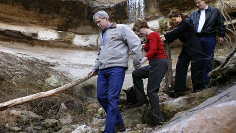 US President George W. Bush (L) holds the hand of First Lady Laura Bush as Mexican President Vicente Fox (R) and his wife Marta follow along after visiting a waterfall on Bush's ranch in Crawford. The two leaders were hoping the weekend visit might reestablish a rapport that was damaged by US irritation at Mexico for its refusal to support the Iraq war. (Photo by Brooks Kraft LLC/Corbis via Getty Images)